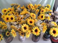 sunflowers and baby's breath in vases on a table