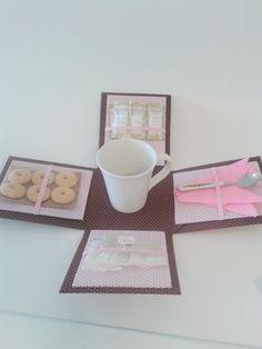 a table topped with trays filled with doughnuts and coffee cup on top of it