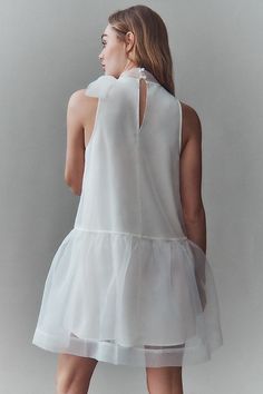 The BHLDN Sophia High-Neck Bow-Tie Organza Mini Dress exudes feminine elegance with its delicate organza fabric, high neckline, and charming bow detail. | Sophia High-Neck Bow-Tie Organza Mini Dress by BHLDN in White, Women's, Size: Medium, Polyester at Anthropologie Chic Mini Wedding Dress With Detachable Bow, Spring Wedding Mini Dress With Satin Bow, Organza Mini Dress For Formal Occasions, Chic A-line Organza Dress, Chic Mini Dress With Satin Bow, Chic Organza Mini Dress For Wedding, Chic Spring Mini Dress With Satin Bow, Feminine Organza Mini Dress, Elegant Organza Mini Dress