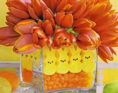 a vase filled with orange flowers and peep holes