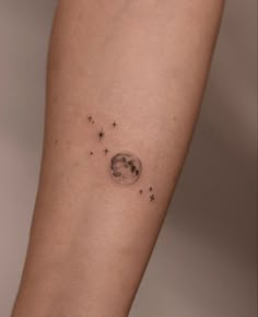 a woman's arm with stars and the moon on it