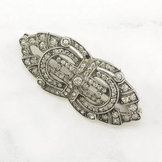 More Unique Sterling Silver Brooches: https://www.etsy.com/shop/SilverStarrs925?section_id=15203699 Beautiful Art Deco Style Silver Brooch This brooch is 1 3/4 inches long It is 3/4 inches wide The brooch weighs 9.2 Grams Stone or design featured on this brooch is Paste Missing one stone  Markings, if any are: Sterling , (Tested & Guaranteed to be Sterling Silver) Condition of this brooch is Very good, missing one diamond, moderate patina NOTE: Variations in color in the pictures are due to reflections. The color in person is a beautiful even silver. Thank you for viewing my item!  Please follow me & favorite my store for a discount. Silver Rings Simple, Sterling Silver Brooch, Old Jewelry, Silver Brooch, Rings Simple, Art Deco Style, Antique Rings, Style Art, Deco Style