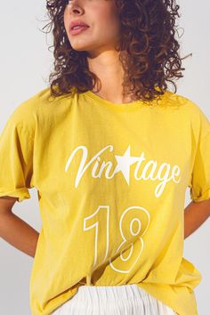 Introducing our T-Shirt with Vintage 18 Text in Yellow, a stylish and comfortable addition to your wardrobe. This t-shirt is designed with a classic crew neckline and short sleeves, providing a timeless and versatile look. Made in Italy, this t-shirt showcases exceptional craftsmanship and attention to detail. The high-quality construction ensures durability and long-lasting wear, allowing you to enjoy this piece for years to come. With its relaxed fit, this t-shirt offers a comfortable and laid Vintage Text, Text T Shirt, Graphic Tees Vintage, Yellow T Shirt, Sunny Yellow, Statement Tees, Vintage Yellow, Fit Style, Shirt Collar