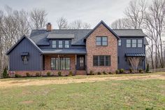 a large brick house sitting in the middle of a field