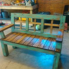 a wooden bench sitting inside of a garage