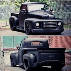 an old black truck parked in front of a chain link fence next to a brick building