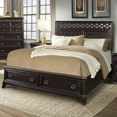 a large bed sitting in a bedroom next to a dresser with drawers on top of it