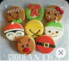 decorated cookies are arranged in the shape of christmas faces