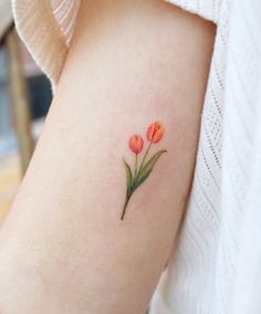 a woman's arm with two flowers on it