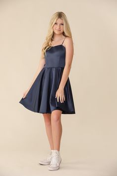 Blonde girl in a Un Deux Trois fit and flare navy satin dress. Teenage Dress Outfits, Banquet Dresses For Teens Long, Grade 8 Grad Dresses Navy Blue, Dance Dresses For Middle School, Teen Semi Formal Dresses, Navy Blue Dresses Short, Cute Prom Dresses For Teens, Promotion Dresses 8th Grade Graduation, Wedding Guest Dress Teenager