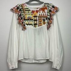 Nwt Off White Multicolor Embroidered Long Sleeve Top. Single Button Closure In Back Pleated Long Sleeves With Button Closure At Wrist Pineapple Embroidered Ruffle At Shoulders Embroidered Motif Lightweight 100% Cotton Crew Neck Measurements Are Flat Lay And Approximate. Bust 22in. Shoulders 15.5in. Length 25in. In Front, 26in. In Back Sleeves 27in. White Long Sleeve Top With Embroidered Hem, White Long Sleeve Top With Embroidered Neckline, White Blouse With Embroidered Sleeves For Fall, Fall Embellished White Tops, White Embellished Long Sleeve Blouse, White Embroidered Top For Fall, White Folk Top With Embroidered Sleeves, White Folk Tops With Embroidered Sleeves, White Embroidered Cotton Top For Fall