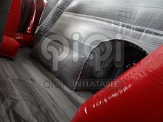 an inflatable slide with red and gray material