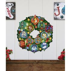 a christmas wreath is hanging on the wall next to other holiday decorations and decorating items