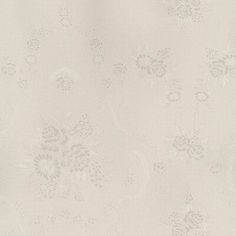 a white wallpaper with small flowers and leaves on the bottom half is shown in this image