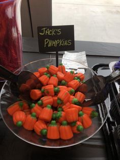 a bowl filled with carrots and peas next to a sign that says jack's pumpkins