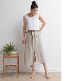 "★★FEATURES 100% Linen Front two pockets Elastic waist skirt Belt skirt Pleated waist details Front split skirt Casual skirt Perfect for Summer, Spring, Autumn ★★ Model Size Height approx 162 cm (5′ 4″) Bust 84 cm (33\") Waist 66 cm (26\") She wears size XS. ★★ Bespoke Order Service If you Request other color Request the length Your height is not between 155 cm- 172 cm Your weight is over 75 kg I can do it for you, It will need some extra fee depending on on your need. Contact with me for more d Summer Pencil Skirt With Side Pockets, Summer Pencil Skirt Bottoms With Side Pockets, Casual Lined Pencil Wrap Skirt, Summer Wrap Skirt With Pockets, Casual Relaxed Wrap Skirt With Pockets, Casual Wrap Skirt With Pockets And Relaxed Fit, Casual Wrap Skirt With Pockets For Summer, Casual Summer Wrap Skirt With Pockets, Beige Flowy Wrap Skirt, Casual