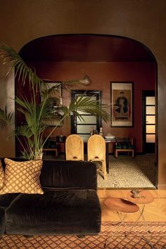 a living room filled with furniture and a potted plant