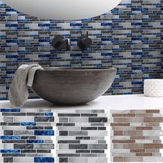 a bathroom with blue and gray tiles on the wall, sink and toilet in it