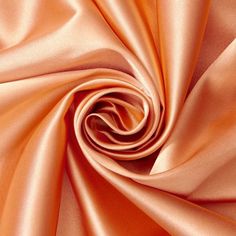 a close up shot of an orange satin fabric