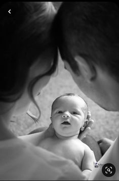 a man holding a baby in his arms