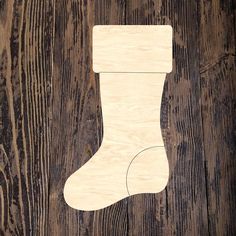 a wooden christmas stocking hanging on a wall