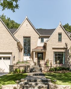 a large brick house with stone steps leading to the front door