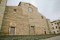 an old brick building with steps leading up to it