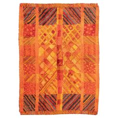 an orange and yellow rug with different patterns on the edges, including squares and stripes