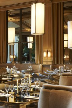 a restaurant with tables, chairs and chandeliers