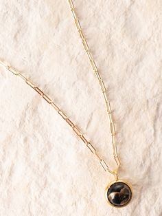 This delicate 16" brass chain holds an 8mm obsidian stone and is a beautiful piece to wear alone or layer. Obsidian symbolizes power and resilience which this necklace perfectly reflects. Each stone will have a unique pattern and color. Size: 16" chain. 8mm stone.Materials: Brass and Obsidian. Based in Bozeman, Montana, Commonform combines a love of creation and gift-giving to produce gorgeous, one-of-a-kind hand-made pieces. Garnet Necklace Gold, Lemon Quartz Necklace, Apatite Necklace, Fan Necklace, Good Luck Necklace, Hope Necklace, Bozeman Montana, Ski Girl, Obsidian Stone