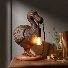 a lamp that is sitting on top of a table next to a book and other items