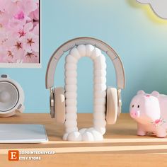 a piggy bank sitting on top of a wooden desk