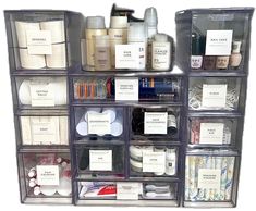 several clear plastic containers filled with different types of cosmetics and personal care items on top of each other