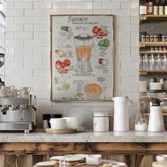 a kitchen counter with coffee cups and saucers on it next to a framed poster