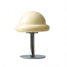 a white table lamp sitting on top of a metal base