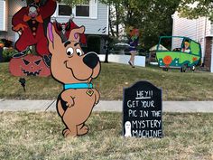 a sign that says hey, get your pic in the mystery machine with a cartoon dog on it