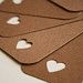 four pieces of brown paper with white hearts on them