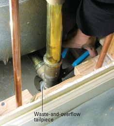 a man working on pipes in an unfinished room