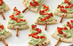 a plate with crackers and christmas trees on top of it, in the middle of an article about how to make appetizers