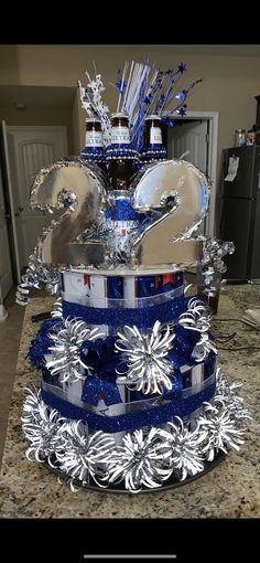 a blue and silver cake sitting on top of a counter