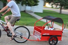 a man riding a bike with a small dog in the sidecar attached to it