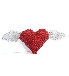 Make your heart soar with this tiny pink, hand- beaded, heart with wings brooch. | Make your heart soar with this tiny pink, hand- beaded, heart with wings brooch. 2.5"x 1" Glass bead exterior; plastic filling Spot clean Handmade and Fairly Traded Our beaded ornaments and pins are made by a women's co- operative in a small village on the shores of Lake Atitlan in Guatemala. The women work in groups of five or so to produce these designs. The glass beads are placed in a multicolored pile upon a f Heart-shaped Valentine's Day Brooch Pin, Heart-shaped Valentine's Day Pins, Heart-shaped Valentine's Day Party Brooches, Heart-shaped Pins For Valentine's Day Gift, Seahorse Ornament, Fox Ornaments, Penguin Ornaments, Elephant Ornament, Lake Atitlan