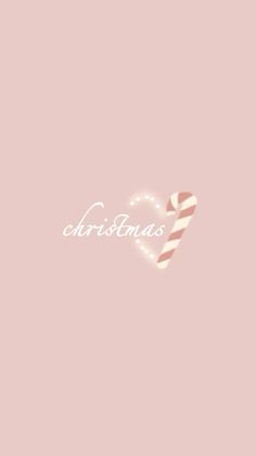 a candy cane is in the shape of a heart on a pink background that says christmas