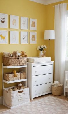 a baby's room with yellow walls and pictures on the wall