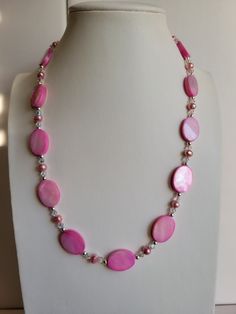 "The oval Mother-of-Pearl beads in this necklace are bright pink. It has clear ab Swarovski crystal beads and pink Freshwater pearls. The findings and remaining beads are sterling silver. It is 19.5\" long and has a 1\" extension with a beaded drop making it adjustable. Custom Orders are always welcome!" Handmade Pink Pearl Beaded Necklaces, Pink Faceted Beaded Round Necklace, Pink Round Beaded Necklaces With Faceted Beads, Pink Round Beaded Necklace With Faceted Beads, Pink Beaded Necklaces With Oval Beads, Pink Single Strand Beaded Necklaces For Jewelry Making, Pink Faceted Beads Necklace, Elegant Pink Beaded Necklaces With Oval Beads, Pink Round Pearl Necklace Gift