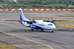 an airplane that is sitting on the tarmac with it's landing gear down