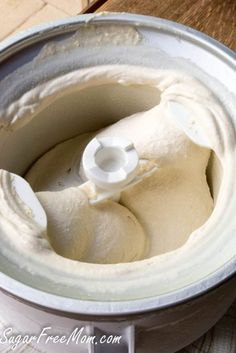 a close up of a food processor on a table with some kind of cream in it