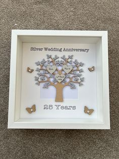 a wedding anniversary tree with butterflies in the shape of hearts is displayed inside a white frame