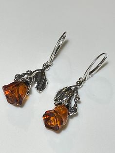 * 100% Natural Baltic Amber, 925 Sterling Silver. * Earring Total Length: 50 mm (2.0"), Width: 17 mm (0.7"). * Stones size: 11 mm x 9 mm  (0.43" x 0.35") . * Total Weight: 7 gram. * Perfect amber jewelry gift for her.  * Color: Honey. * These Earrings are for adults only. Natural Baltic Amber Rose Earrings. Elegant Drop Rose Natural Baltic Honey Amber Earrings. Did you know that Amber was one of the first materials ever used for accessorizing? Ornaments made out of amber were found on prehistori Prehistoric People, Natural Jewelry, Amber Rose, Amber Earrings, Tiny Earrings, Earrings Elegant, Stone Age, Jewelry Sterling Silver, Amber Jewelry