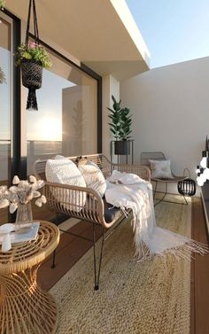 an outdoor living area with wicker furniture and plants